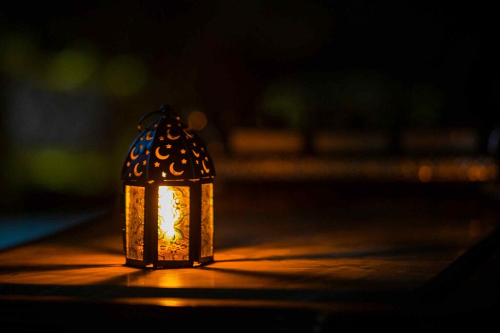 A glowing lantern with crescent motifs creates a warm ambiance for Ramadan or Eid.